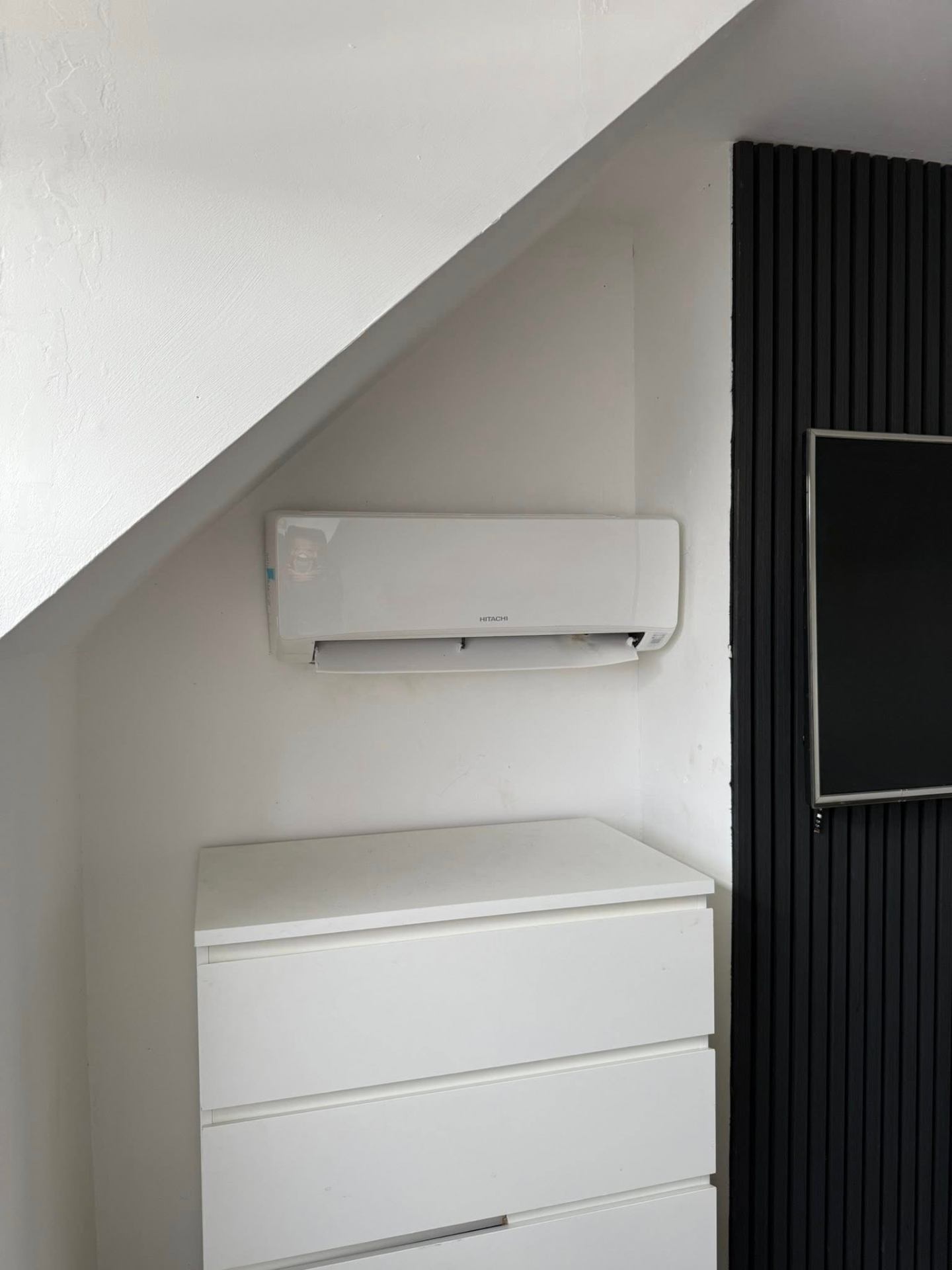 Hitachi air conditioning indoor wall unit installed in a Northampton bedroom for cooling and heating