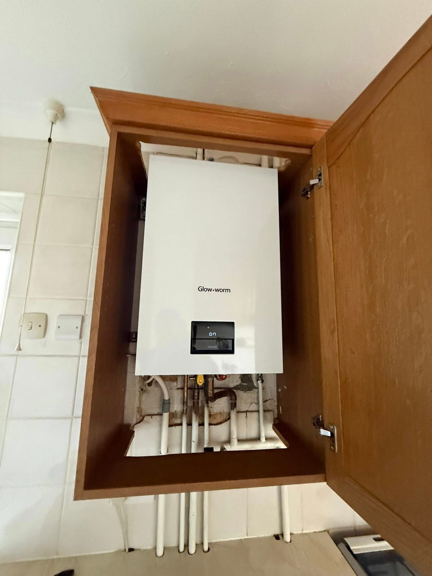 Glow-worm combi boiler installation in a Northampton kitchen cupboard by J Lamb Plumbing & Heating